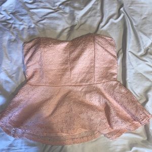 A baby pink strapless peplum shirt